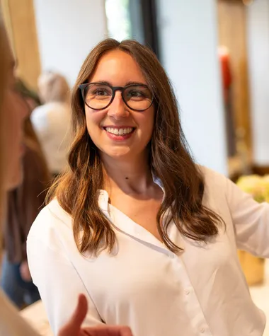 Maria Pastor smiling as she talks with a client in a clothes shop